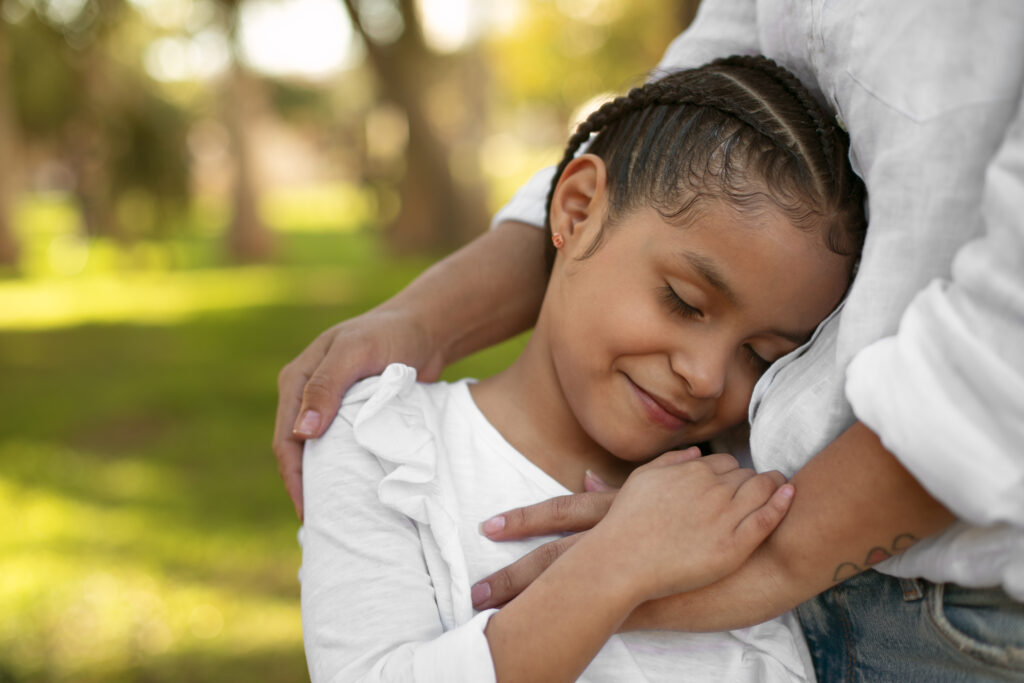 Daughter cuddling into mother