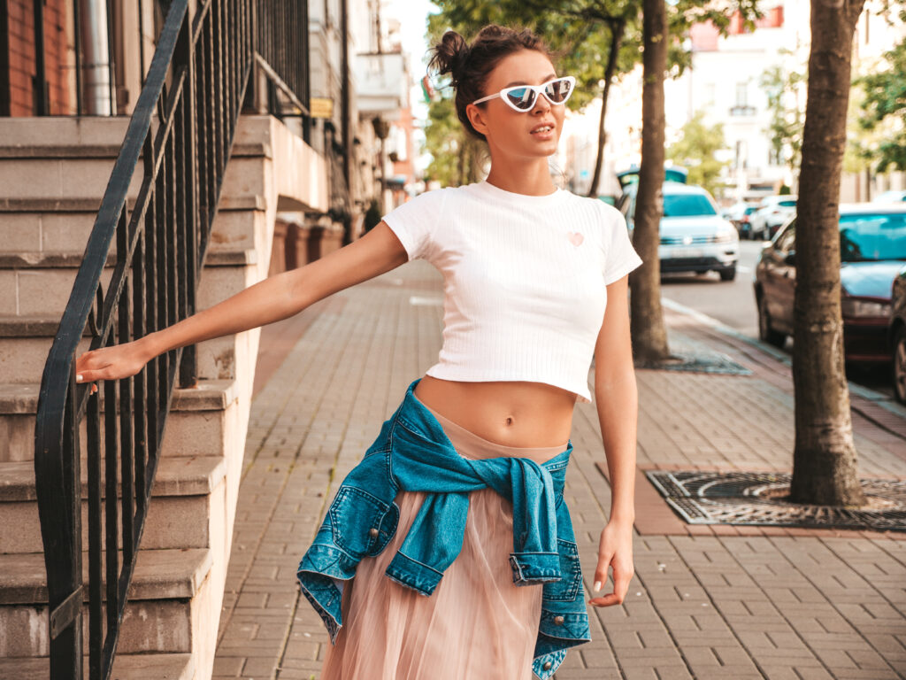 Woman in a crop top standing on a street