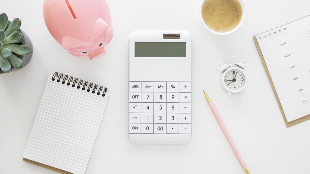 Flatlay image of a calculator and notepad