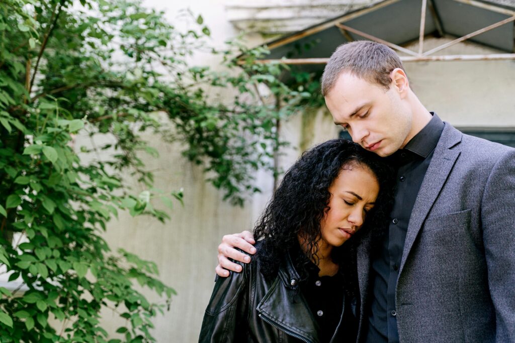 Couple comforting each other outdoors