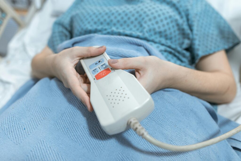 Patient in a bed holding a call button