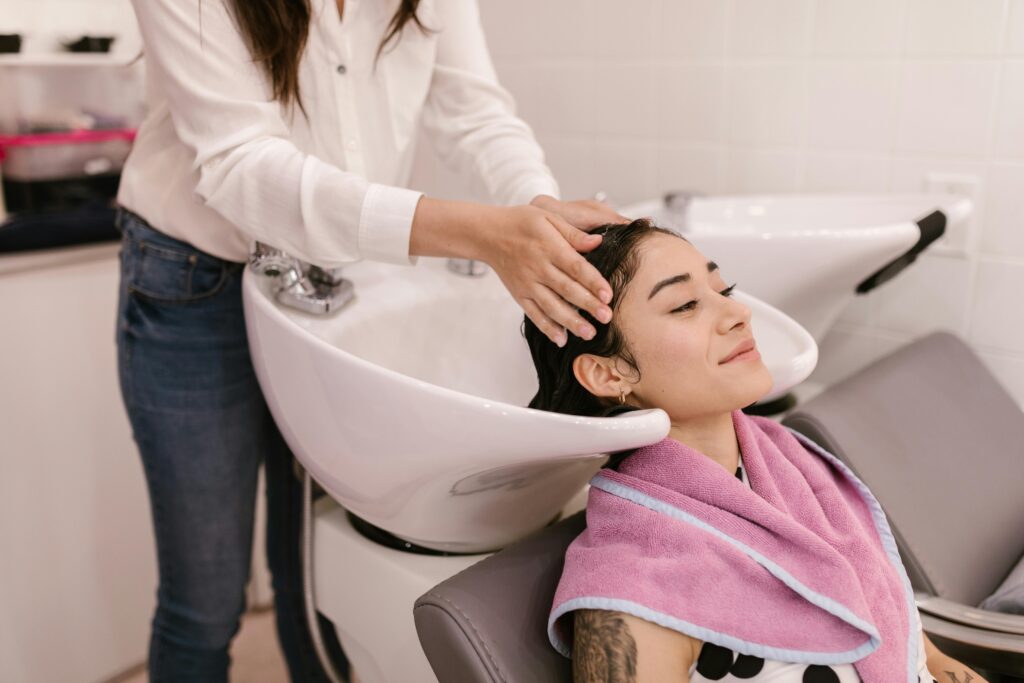 Woman getting hair washed in a basin at a hair salon