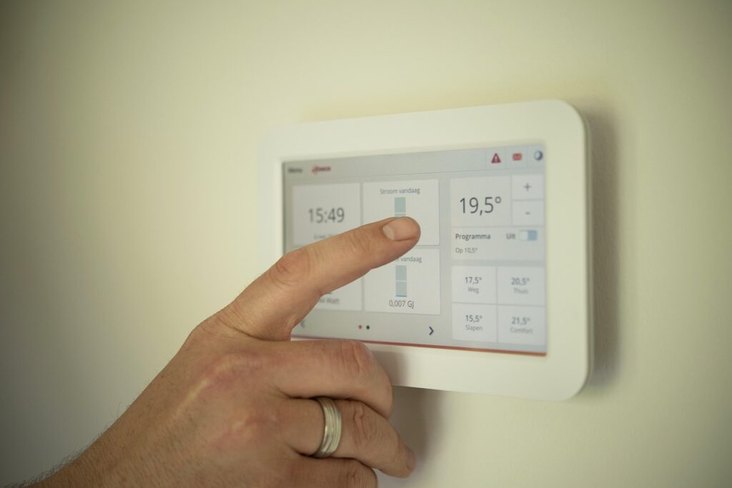 Anon person pressing a heating system panel