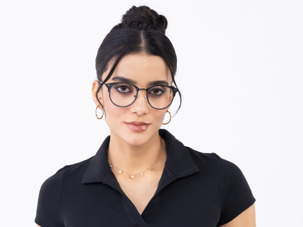 Woman with black hair in a bun wearing glasses