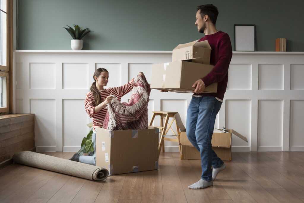 Man and woman packing houses to move house