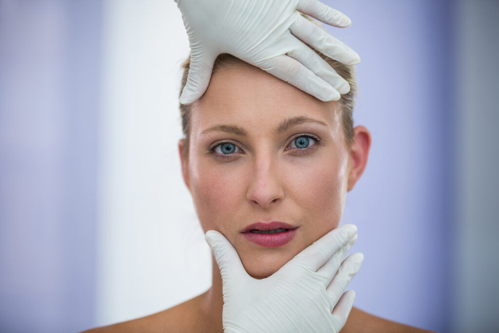 Doctor examining female patient face