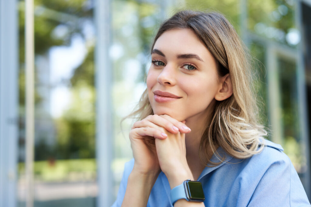 Close up portrait of a woman smiling and wearing makeup