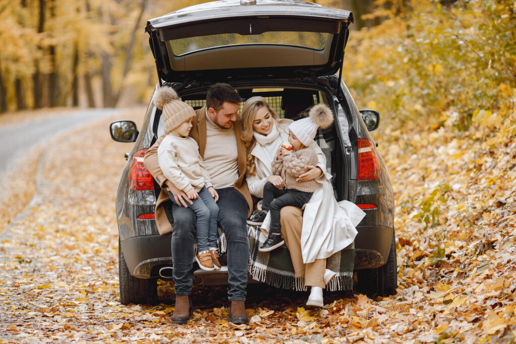 Family sitting in the trunk of their car