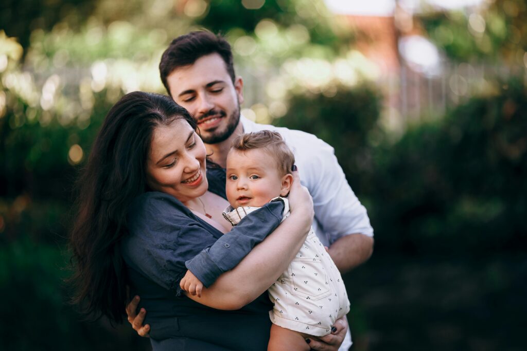 Mother and father with a baby outdoors