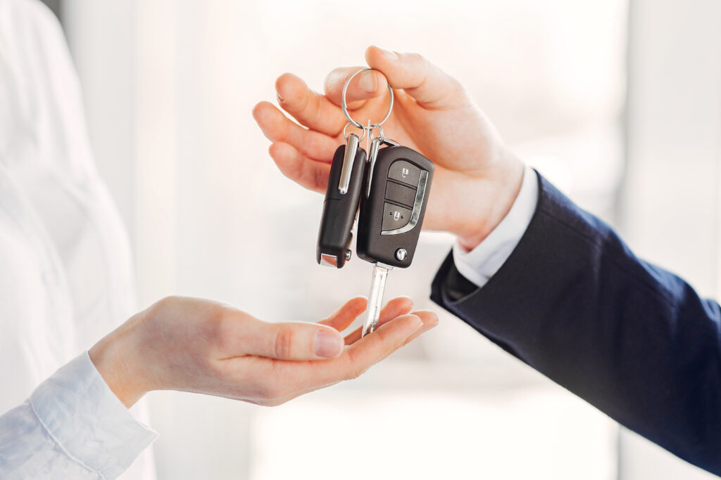 Anon person handing another anon person car keys