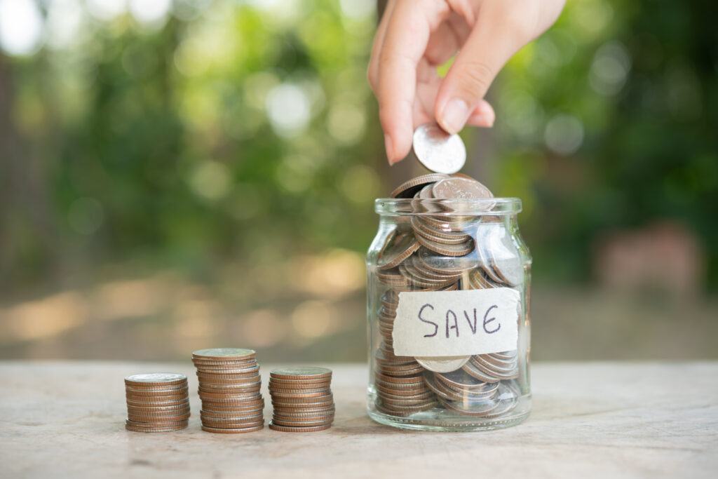 Anon person saving coins in a glass jar