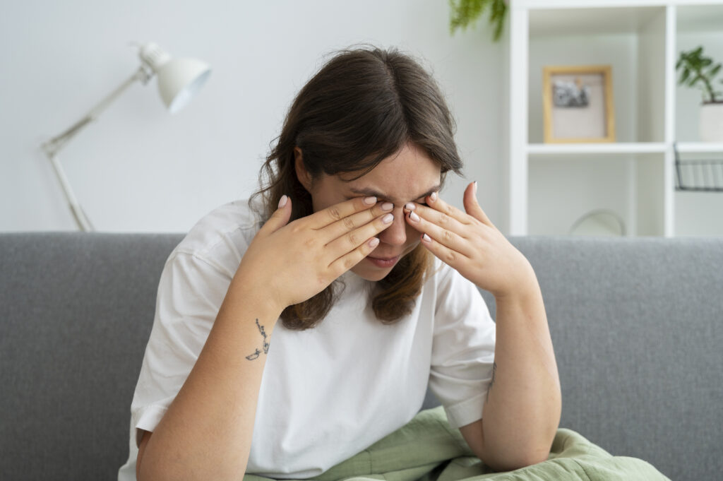 Woman rubbing her eyes