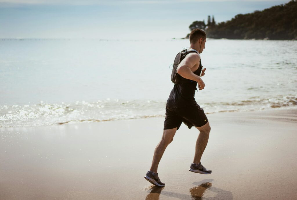 Man running on the shoreline at a beach