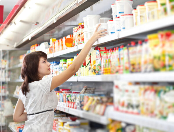Woman choosing product to buy in a supermarket