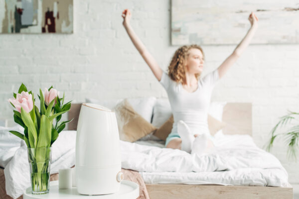 Woman in a beautiful bright bedroom