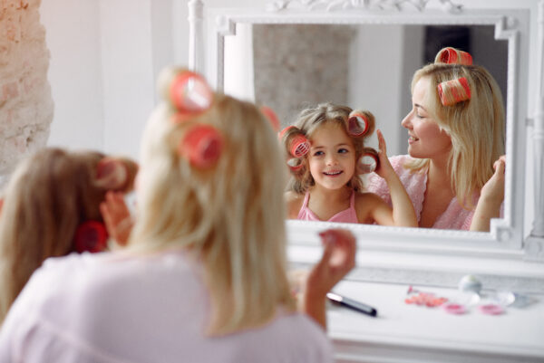 Mother and daughter with rollers in their hair