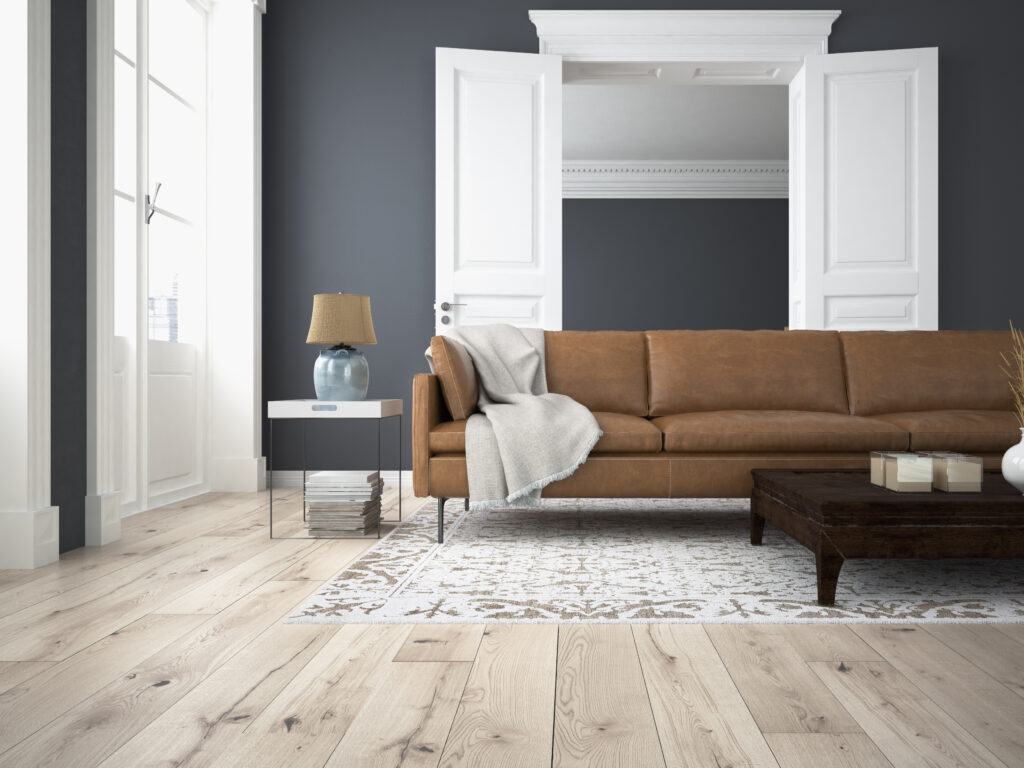 Living room with wooden floor and tan coloured couch