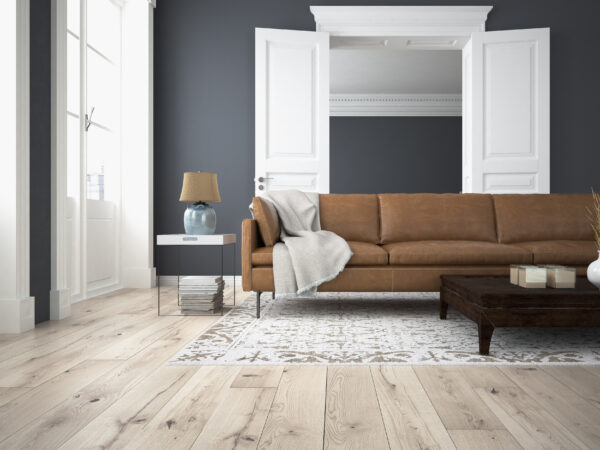 Living room with wooden floor and tan coloured couch