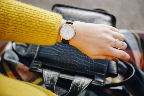 Anon person wearing a yellow jumper showing a luxury watch