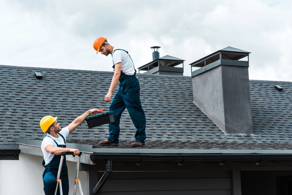 Two contractors working on a roof repair