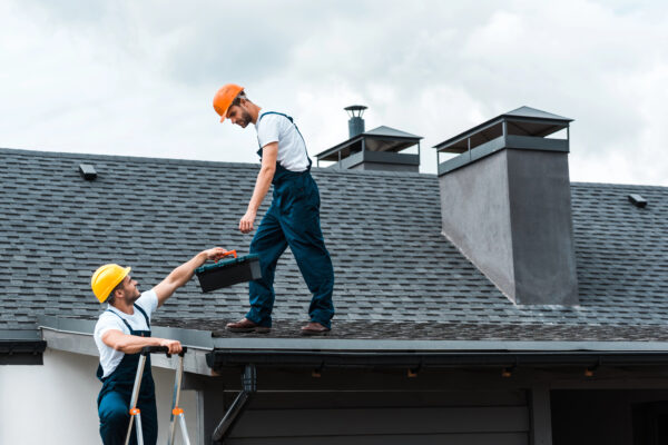 Two contractors working on a roof repair