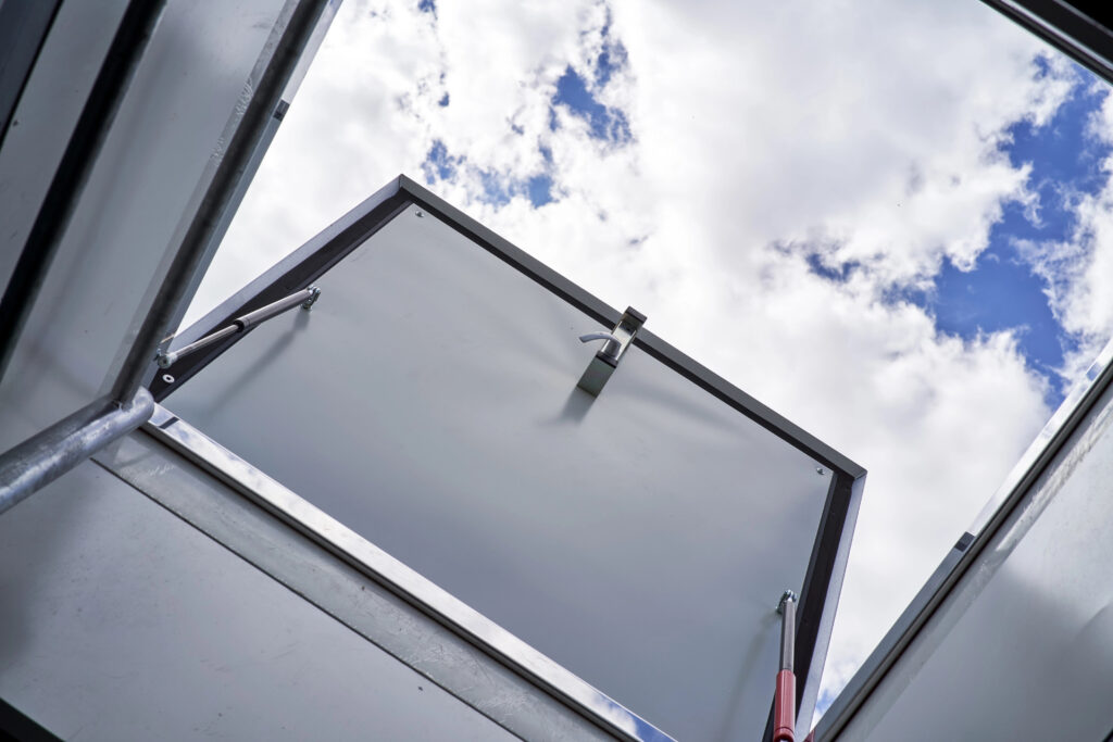 View of a roof access hatch with cloudy sky in the background