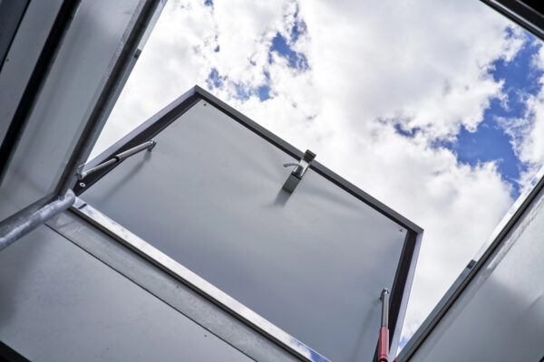 View of a roof access hatch with cloudy sky in the background