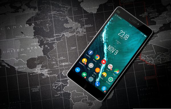 Mobile phone with world map in the background