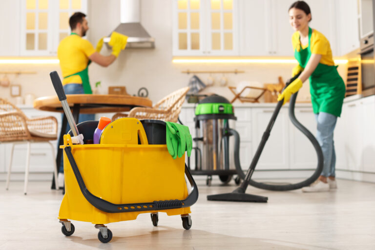 Professional cleaners cleaning a kitchen in a domestic home