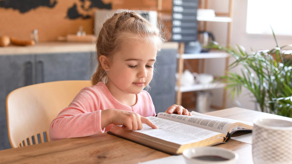 Girl reading Bible at home