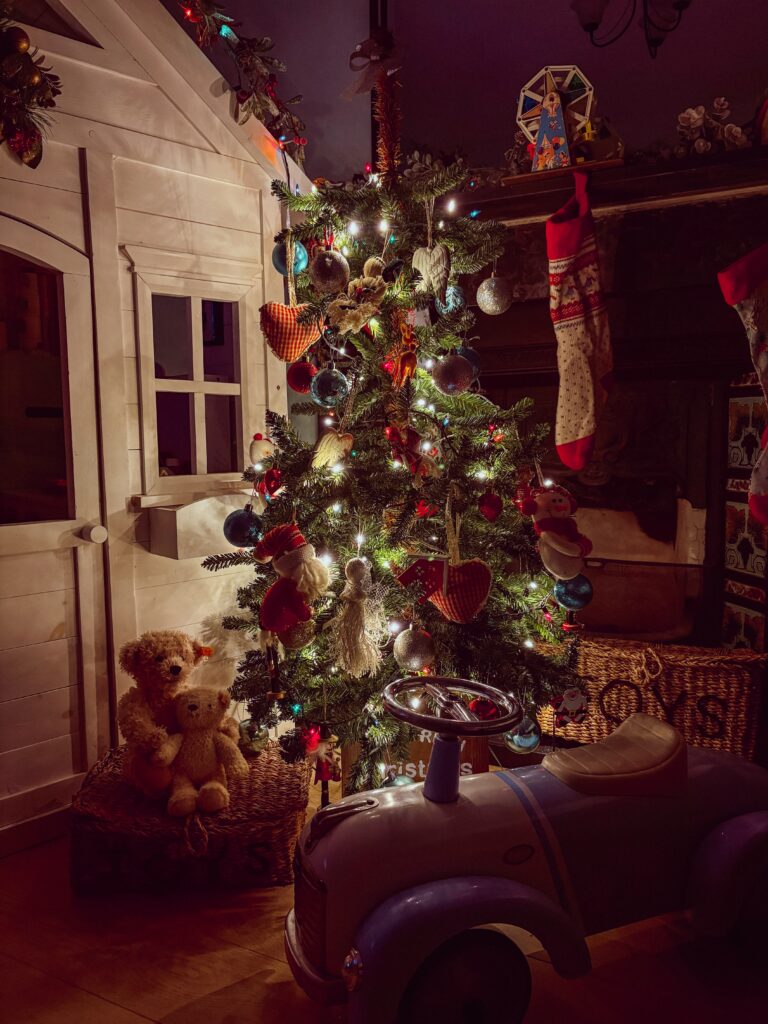 Little Christmas tree decorated with 90s style Christmas lights