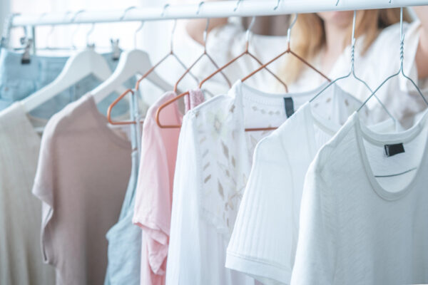 Pastel coloured clothes on hangers