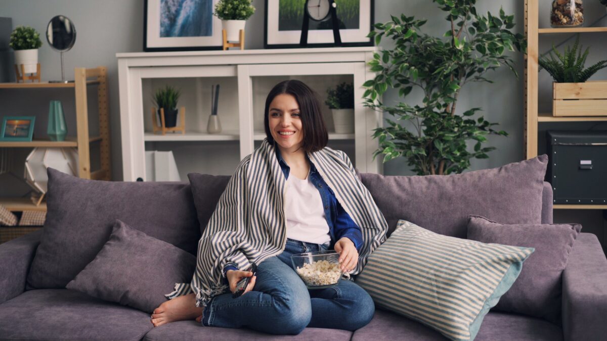 Woman sitting on a sofa to watch TV
