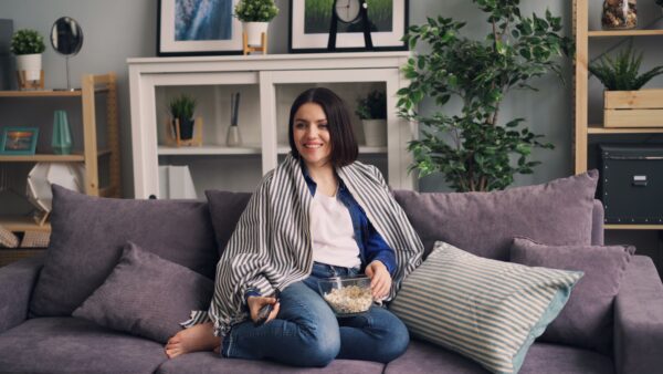 Woman sitting on a sofa to watch TV